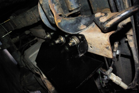1995 Ford Bronco - Close-up of a vehicle's undercarriage, focusing on the hitch mounting hardware.