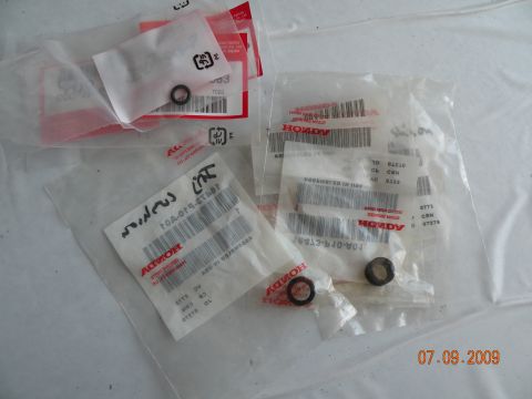 1994 Acura Integra - Several small Honda parts are shown in their original packaging, with part numbers and branding clearly visible.