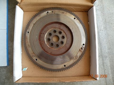 1994 Acura Integra - This is a used flywheel, showing signs of rust and wear, placed inside a cardboard box.