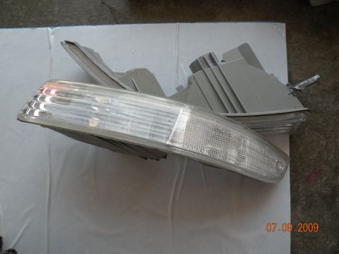 1994 Acura Integra - Pair of car headlight assemblies shown from the side, likely for a front corner.