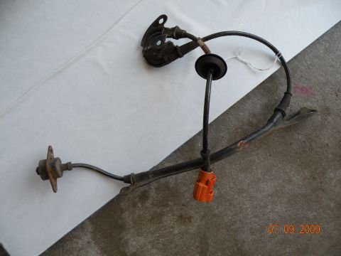 1994 Acura Integra - This is a part from a vehicle, likely an ABS speed sensor assembly, shown on a flat surface.