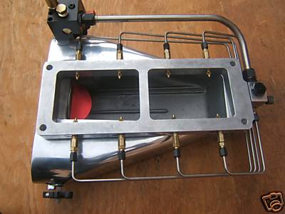 1972 Ford Ranchero - Polished fuel injection system with dual throttle bodies and braided fuel lines, likely for a performance engine.
