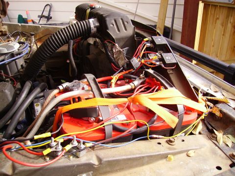 1978 Ford Bronco - The engine bay shows a complex setup with dual batteries and extensive wiring, obscuring specific vehicle details.