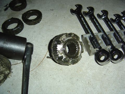 1986 Ford Bronco - Automotive parts and tools laid out on a concrete surface, likely for repair or maintenance.