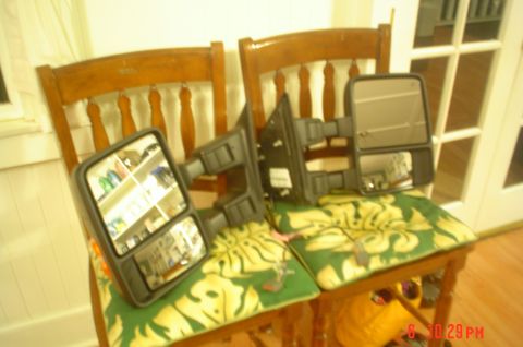 2005 Ford Excursion - Pair of aftermarket towing mirrors, likely for a truck or SUV, are placed on chairs.