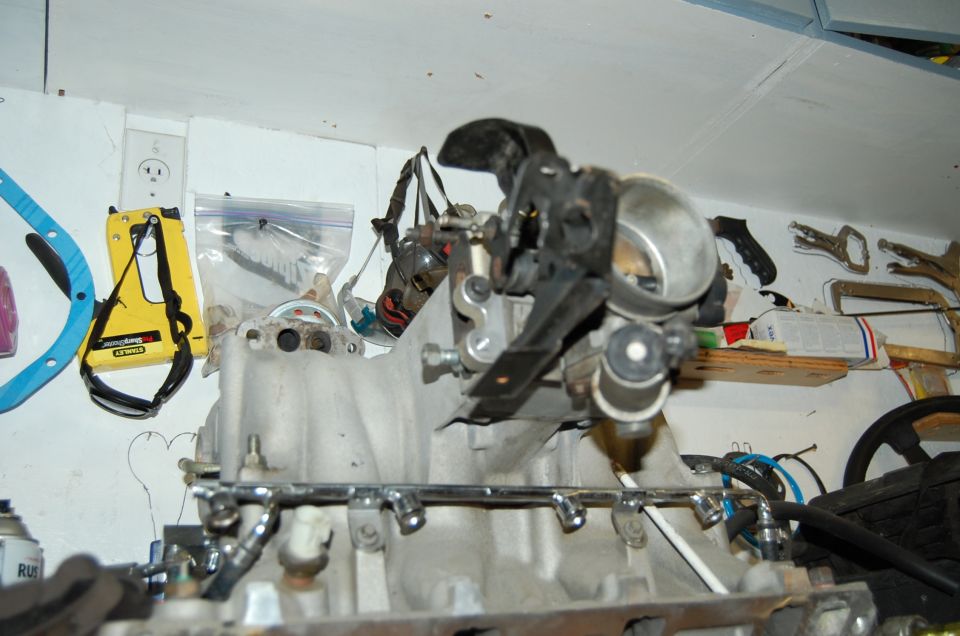 Engine intake manifold with throttle body and fuel rails