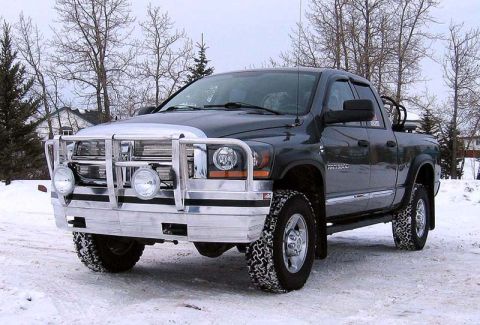 2005 Dodge 3500 - This 2005 Dodge 3500 pickup truck is equipped with a heavy-duty chrome grille guard and auxiliary lights, seen here in a snowy environment.