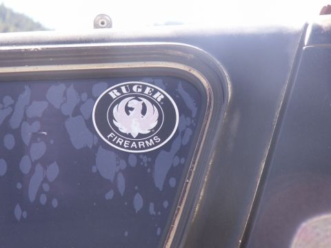 1986 Ford Bronco - A Ruger Firearms sticker is visible on the dark-colored door of a vehicle.