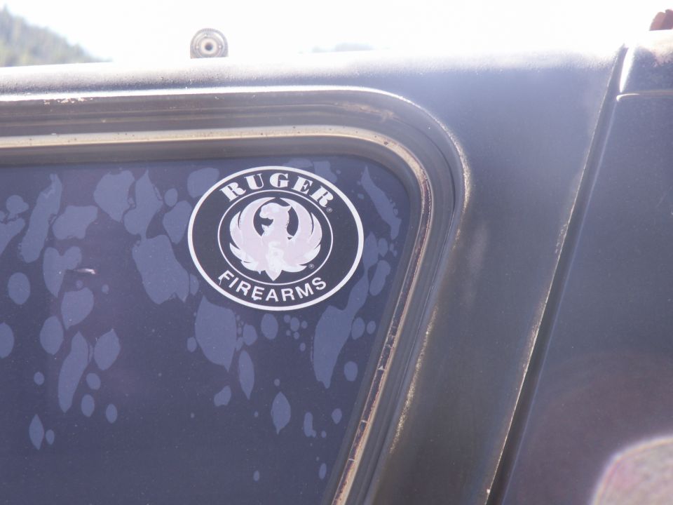 Ruger Firearms decal on a mud-spattered truck door window