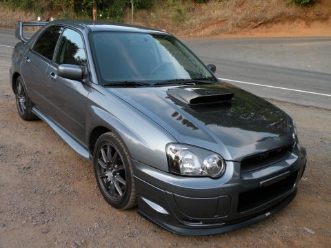 1998 Subaru Legacy - A gray Subaru Impreza WRX STI is parked on the side of a road with a dirt shoulder.