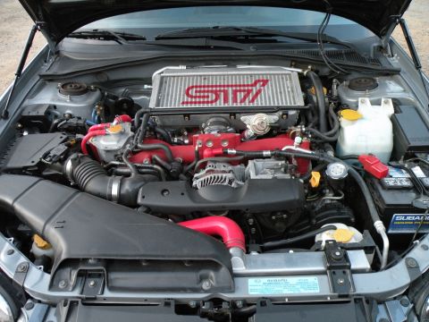 1998 Subaru Legacy - Engine bay of a 1998 Subaru Legacy, an STI intercooler and modified intake system.