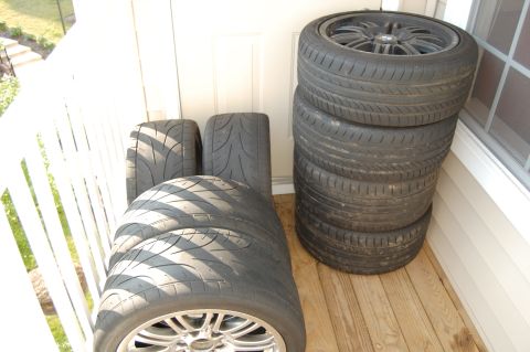 2002 BMW M3 - Several tires are stacked, with one wheel visible at the bottom.