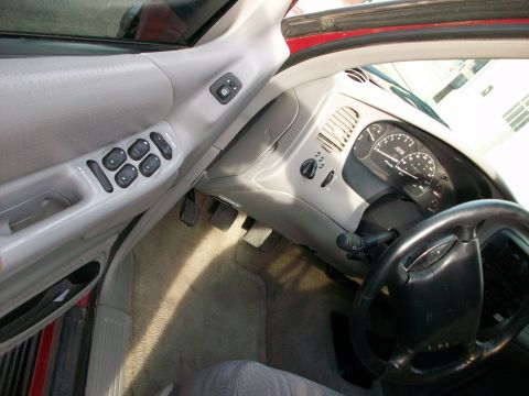 1996 Ford Explorer - Interior view of a 1996 Ford Explorer, showing the driver's side door controls, dashboard, and steering wheel.