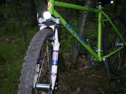 1981 Garelli Rally Sport - A green bicycle with visible "Rock Shox" branding on its front suspension is parked outdoors.