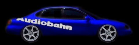 1998 Ford Taurus - A blue sedan with custom wheels and "Audiobahn" branding is shown from the side against a black background.