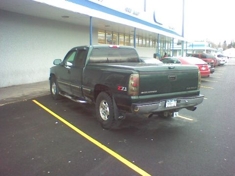 1974 Ford Ranchero - A green Chevrolet pickup truck is parked in a lot, showing its rear and side profile. The truck appears to be a 2003 model.