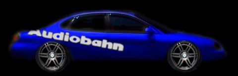1998 Ford Taurus - A blue sedan with custom wheels and 'Audiobahn' text is shown against a black background.