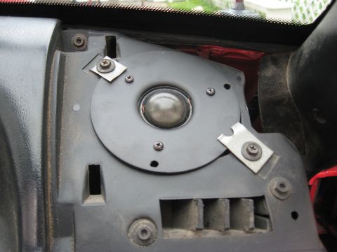 1975 Ford Torino - Close-up of an interior component, possibly a speaker or vent, with visible screws and a domed cover.