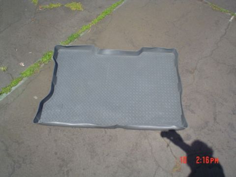 2005 Ford Excursion - A gray rubber floor mat with a diamond pattern is shown on a paved surface.