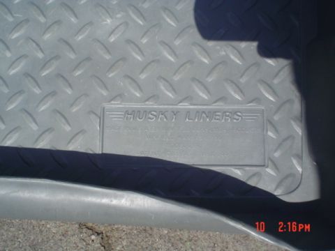 2005 Ford Excursion - Embossed Husky Liners logo on a diamond plate textured floor mat.