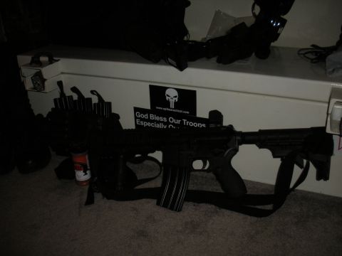 1996 Ford Bronco - An assault rifle is displayed with ammunition and tactical gear, alongside a sticker that says 'God Bless Our Troops'.