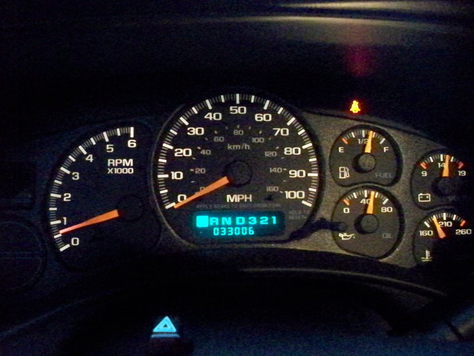 Dashboard gauges showing 033006 miles and 'RND 3 2 1' in the gear indicator. Speedometer reads 0 MPH