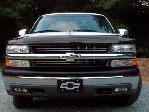 2002 Chevrolet Silverado 1500 - Front grille view of a black Chevrolet Silverado showing chrome grille bars and the Chevy bowtie emblem.