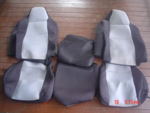 2005 Ford Excursion - Car seat covers are displayed on a wooden surface, showing their two-tone design.