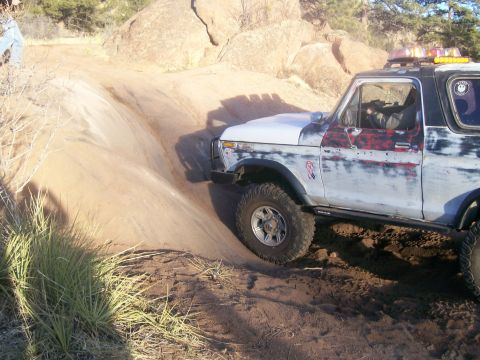 1978 Ford Bronco - A 1978 Ford Bronco navigates a steep, sandy incline during an off-road excursion.