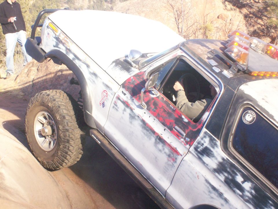 Distressed 1978 Ford Bronco on rocky terrain, 3q-front view