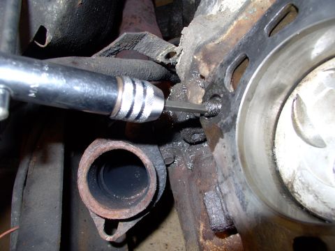 1986 Ford Bronco - After heating around the busted bolt, with the propane torch, I pounded the easy out into the hole and put the ratchet tap handle over it a…