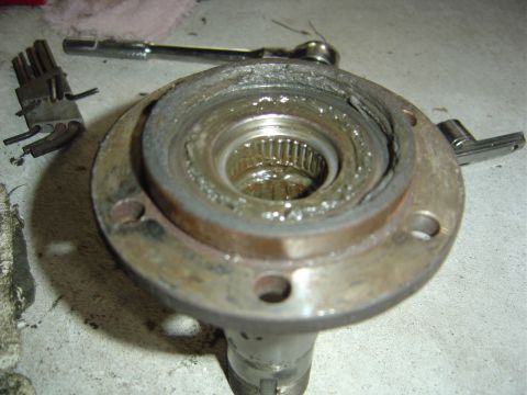 1986 Ford Bronco - This image shows a heavily greased and worn wheel bearing assembly, likely needing replacement.