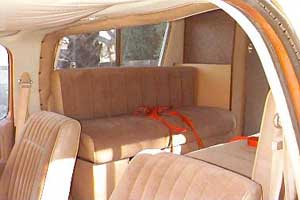 1991 Ford Bronco - Van interior with front and rear seating visible, some orange straps are present.