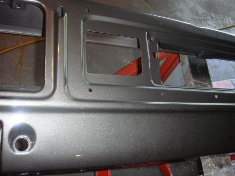 1979 Ford F-250 - Close-up of a vehicle's dashboard panel, showing its metallic finish and cutouts for instruments.