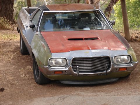 1973 Ford Ranchero - This Ford Ranchero shows signs of wear and tear with its varied paint colors and weathered exterior.