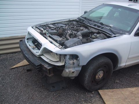2003 Ford Crown Victoria - Front view of a 2003 Ford Crown Victoria with the hood up and engine exposed.