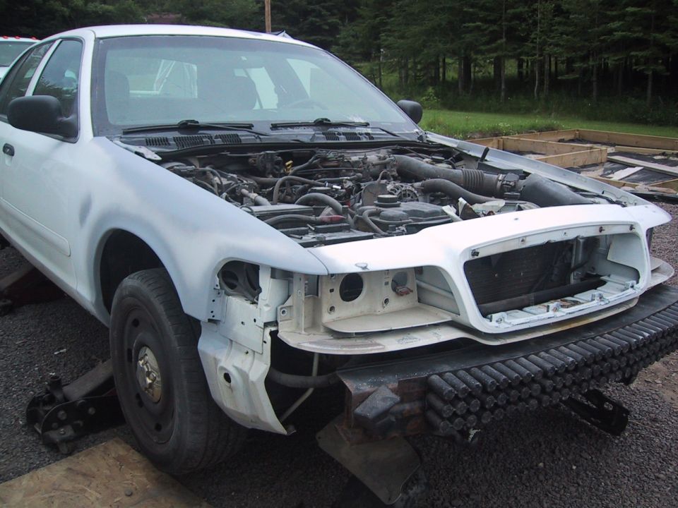 2003 Ford Crown Victoria, front view, hood open showing engine, undergoing repairs