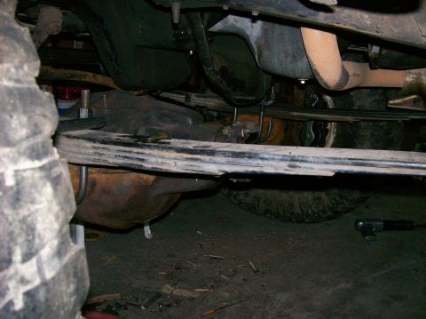 1989 Ford Bronco - Undercarriage detail of a vehicle, focusing on suspension and exhaust components.