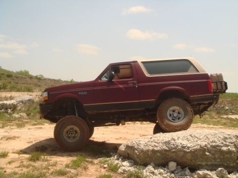 1992 Ford Bronco - This 1992 Ford Bronco is navigating a rocky trail under a partly cloudy sky.