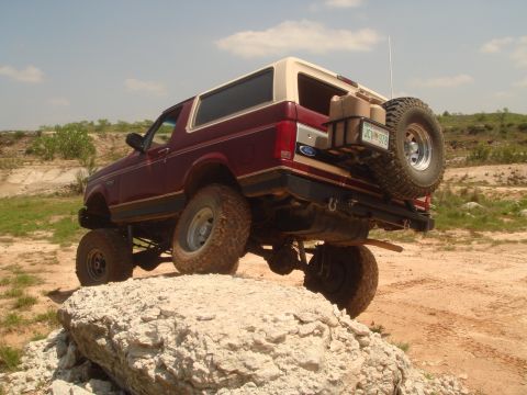 1992 Ford Bronco - This 1992 Ford Bronco is shown off-roading, demonstrating its capability on rough terrain.