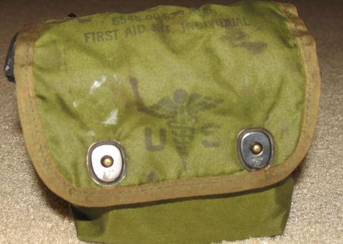 1984 Ford Bronco - This is a close-up of an individual first aid kit, marked with "US" and a caduceus symbol.