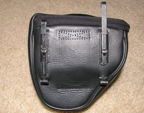 1984 Ford Bronco - A black leather pouch with a zipper closure and metal mounting clips is shown.