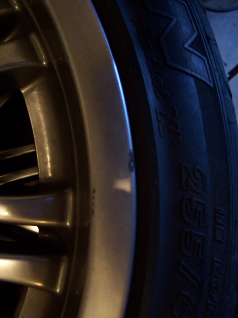 Close-up of a multi-spoke alloy wheel and tire sidewall marked Radial 255/4…