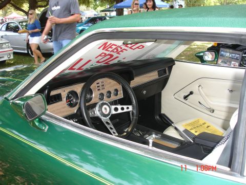 1978 Ford Mustang II - Interior view of a green 1978 Ford Mustang II, showing the dashboard, steering wheel, and seating.