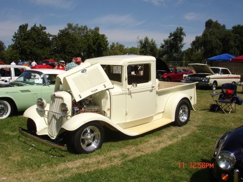 1978 Ford Mustang II - A vintage pickup truck is displayed at an outdoor car show with other vehicles present.