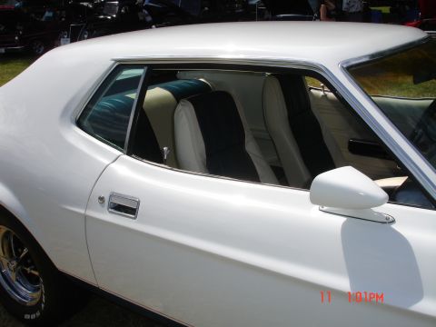 1978 Ford Mustang II - White coupe with a two-tone interior, seen at a car show with other vehicles present.