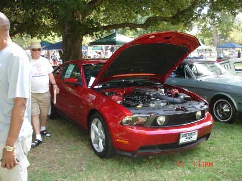 1978 Ford Mustang II - A red Ford Mustang is displayed with its hood open at an outdoor car show.