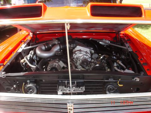 1978 Ford Mustang II - Close-up of a powerful engine bay with a prominent supercharger and custom intake system.