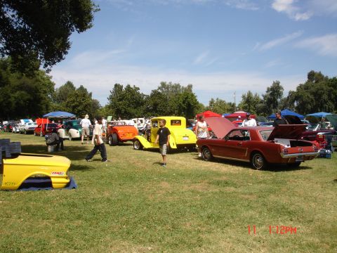 1978 Ford Mustang II - Several classic cars are displayed on a sunny day at an outdoor gathering.