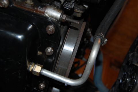 1985 Mercury Grand Marquis - Close-up of engine components, including a belt and metal pipe, with a website watermark visible.